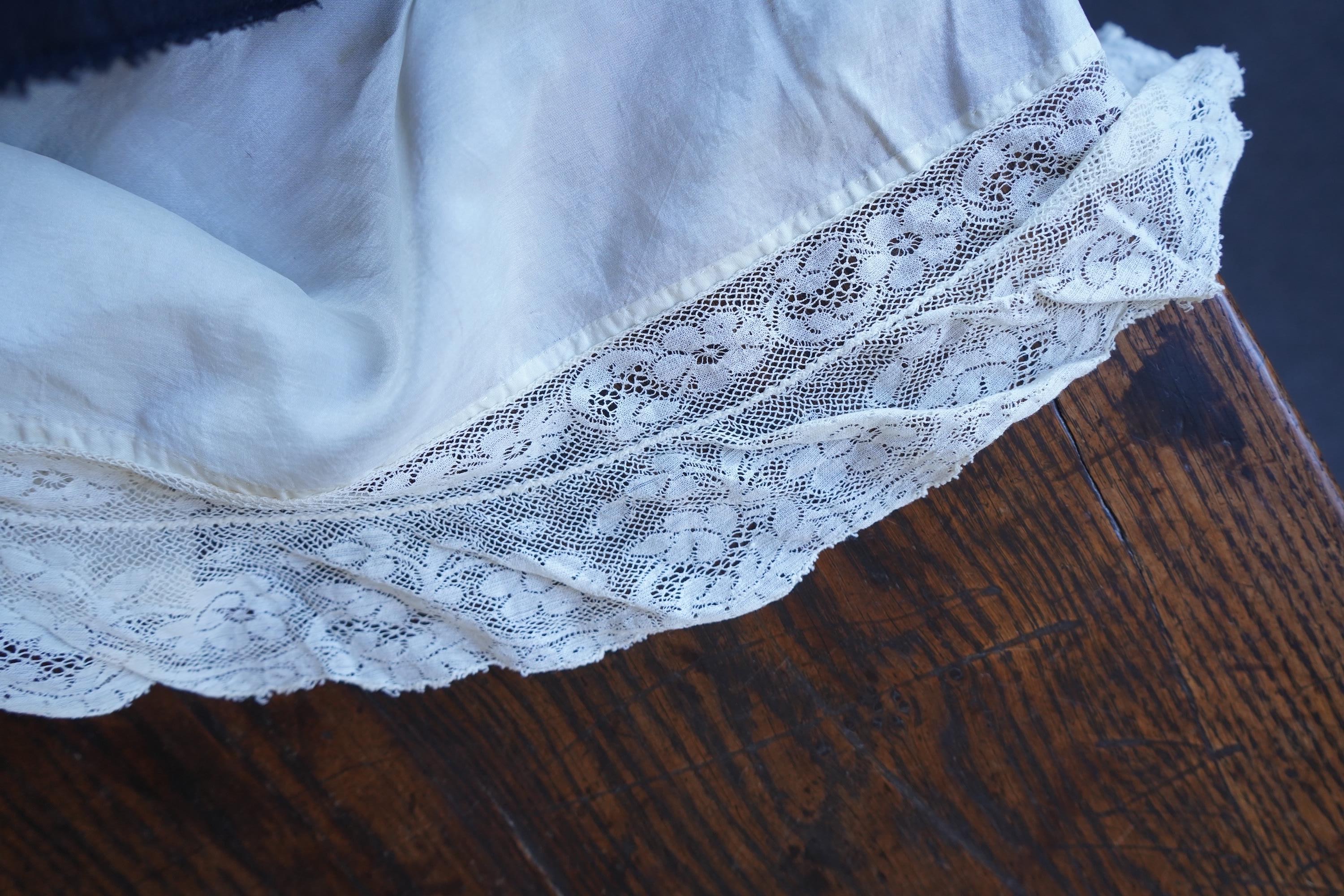 A collection of 1920's-30's silk and satin camisole slips, two cream silk and lace jackets, a lace blouse a silk embroidered blouse, a silk cami, and a collection of silk stockings., Condition- good